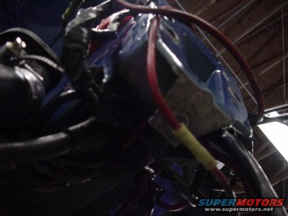 Close-up of blue plastic housing with red and yellow wires connected to an engine wiring harness