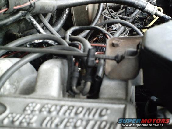 Close-up of engine bay, showing "ELECTRONIC FUEL INJECTION" text on a component