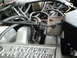 1987 Ford Bronco - The engine bay is filled with wires and hoses, with a clear view of the electronic fuel injection system.