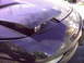 1997 Ford Probe - Close-up of a 1997 Ford Probe's pop-up headlight assembly, showing dust and scratches.