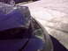 1997 Ford Probe - The rear corner of a vehicle shows damage and wear on the bumper and body panel.
