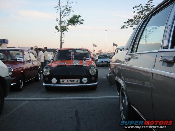 Orange and black Mini Cooper with racing stripes and license plate W 17901J