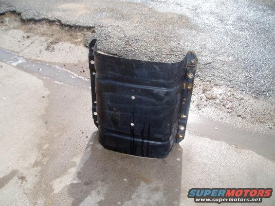Black metal fuel tank with mounting holes, seen from the front