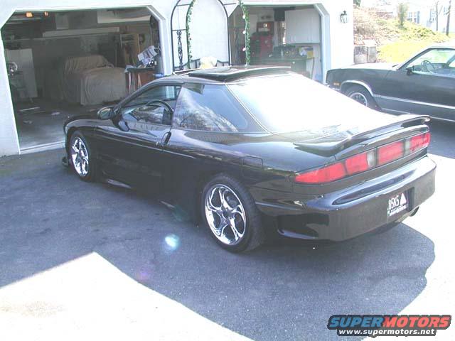 1996 Ford Probe rear view with aftermarket wheels parked in a driveway