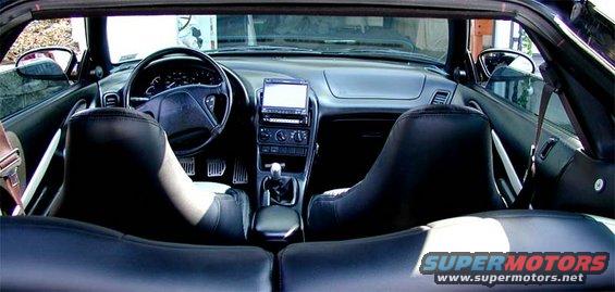 Interior view of black convertible with leather seats and aftermarket stereo