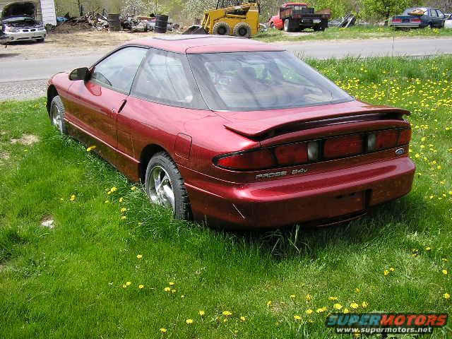 1994 Ford Probe GT rear view, parked in a grassy field with yellow flowers