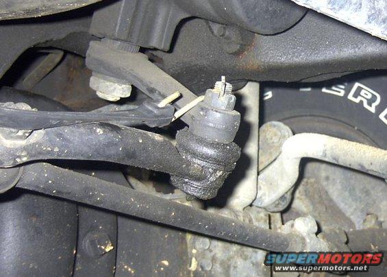 As I was doing this project "Lone Ranger" style, I needed to apply outward pressure
on the axle shaft u-joint. The only way I could quickly resolve this was to place a
standard crow bar behind the u-joint and using a black rubber tie-down strap to
pull tension on the crow bar. I simply hooked the other end to the Pittman arm