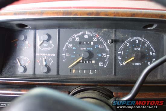 Dashboard with speedometer, tachometer, fuel gauge, oil pressure gauge, and temperature gauge