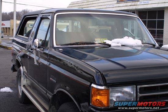 Black 1989 Ford Bronco parked outside a building
