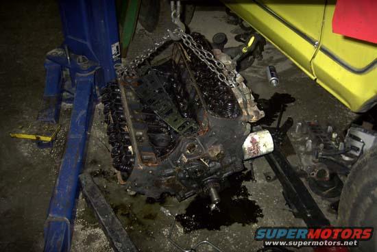 Engine removed from vehicle, suspended by chains