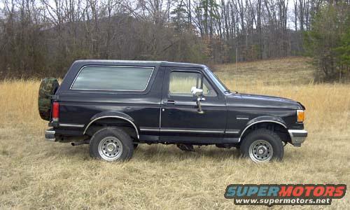 Black 1989 Ford Bronco side view with spare tire on rear