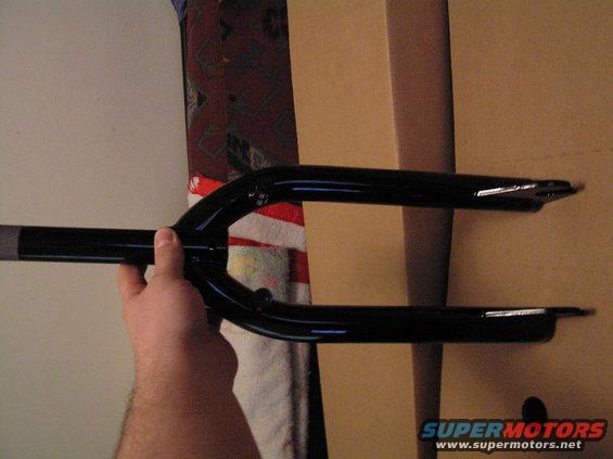 Hand holding a black bicycle fork