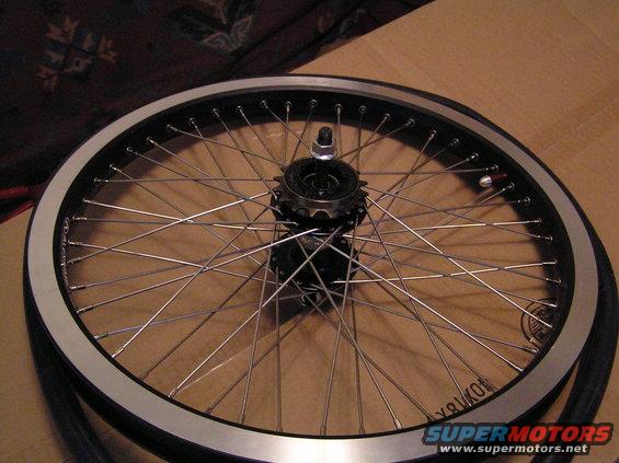 Bicycle wheel with silver rim, black spokes, and a freewheel hub