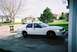 2000 Ford Crown Victoria - A white 2000 Ford Crown Victoria is parked in a suburban driveway on a partly cloudy day.