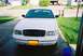 2000 Ford Crown Victoria - A white 2000 Ford Crown Victoria is parked in a driveway, facing the camera.