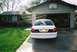 2000 Ford Crown Victoria - Rear view of a white 2000 Ford Crown Victoria parked in a driveway with a snake decal on the rear window.