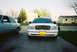 2000 Ford Crown Victoria - A white 2000 Ford Crown Victoria is parked in front of a suburban house, with another car to its left.