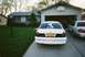 2000 Ford Crown Victoria - Two Ford Crown Victorias are parked in a driveway in front of a suburban house.