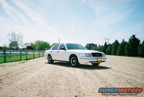 White 2000 Ford Crown Victoria parked on a gravel road