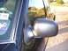 2003 Ford Ranger - Side mirror and windshield frame detail on a vehicle, with a sticker showing '3 05'.
