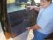 2003 Ford Ranger - Man removing the interior door panel of a 2003 Ford Ranger.