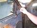2003 Ford Ranger - A hand is shown placing an insulation panel inside the door panel of a vehicle.