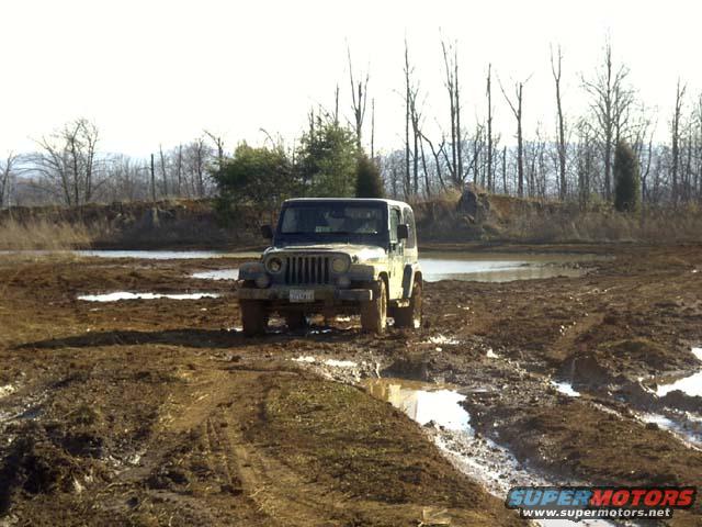 Jeep Wrangler stuck in mud on an off-road course