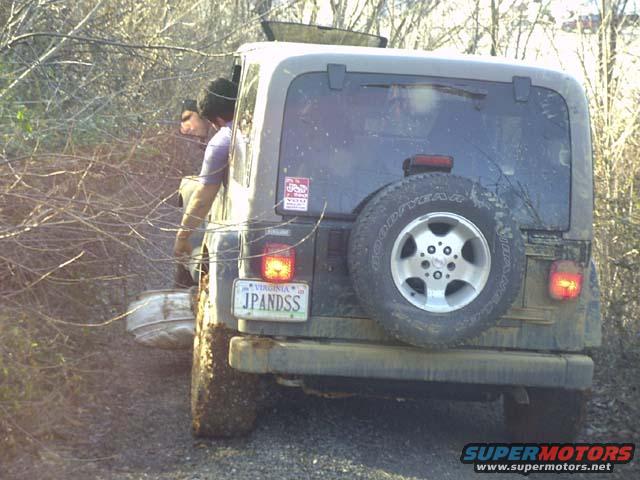 Jeep Wrangler on a dirt trail with a spare tire on the back and a Virginia license plate