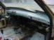 1998 Volkswagen Jetta - The interior of a car shows a disassembled dashboard and exposed wiring, with a dirty floor.