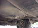 1998 Volkswagen Jetta - Undercarriage view reveals the fuel tank and rear axle assembly of a vehicle.