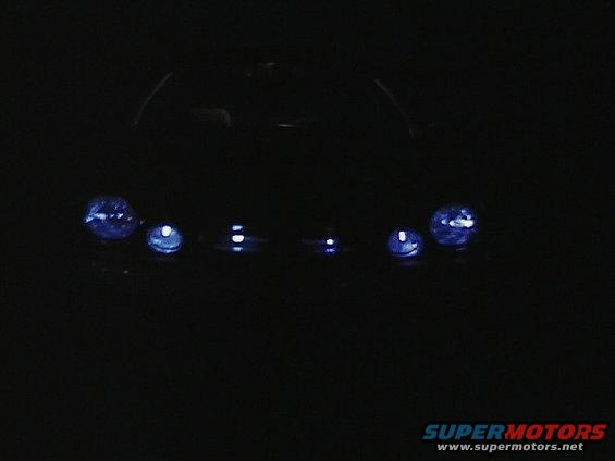 Two headlights on a dark background