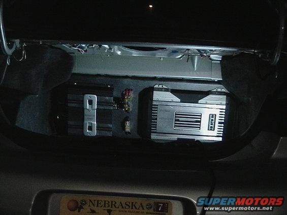 Car stereo system with a digital display and buttons, installed in a dark car interior