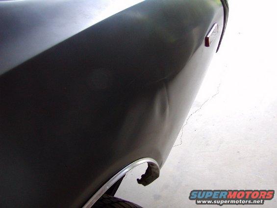 Dark fender with dent and chrome trim