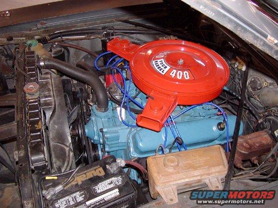 Engine bay with blue engine block, red air cleaner labeled "400 FOUR BARREL"