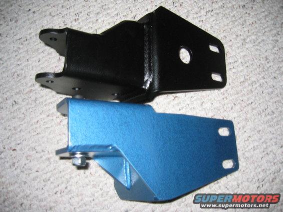 black and blue metal brackets on a carpeted surface. One has a Supermotors.net watermark