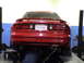 1997 Ford Probe - A red coupe is shown from the rear on a vehicle lift in a garage setting.