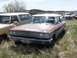 1968 Ford Coupe - This weathered 1963 Ford station wagon sits in a junkyard, its chrome grille and California license plate still visible despite the rust.