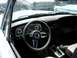 1968 Ford Coupe - Interior view of a 1968 Ford Coupe, its dashboard and steering wheel, with another vehicle visible in the background.