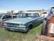 1968 Ford Coupe - Junkyard scene with a 1963 Ford Galaxie sedan and other vehicles under a clear sky.