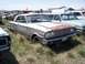 1968 Ford Coupe - A weathered coupe with a distinctive grille and dual headlights is parked in a field of tall grass.