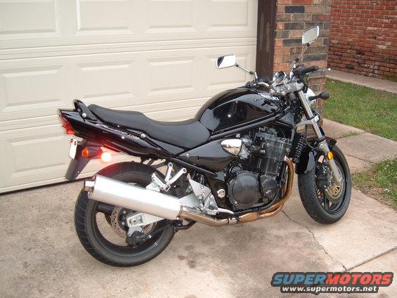 Black 2001 Suzuki Bandit motorcycle parked in front of a garage