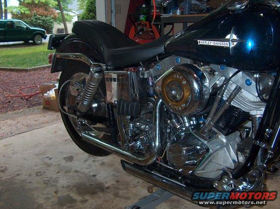 1976 Harley-Davidson Super Glide motorcycle, dark blue, side view, in garage