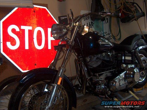 Black motorcycle with chrome accents and a stop sign in the background