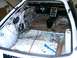 1996 Ford Probe - The interior of a car is shown with its door panels removed and wiring exposed, indicating it is undergoing repairs or modifications.