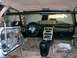 1996 Ford Probe - The interior of a 1996 Ford Probe shows modifications including a roll cage and aftermarket gauges, with door panels removed.