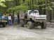 1979 Ford Bronco - A lifted, muddy Chevrolet pickup truck is seen from the rear during an off-road event.