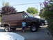 1982 Ford F-250 - A modified brown van with a roof rack and lifted suspension is parked on a paved surface.