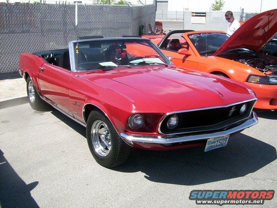 red convertible classic car parked next to an orange modern car