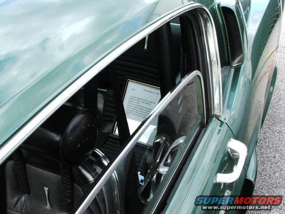 Interior view of a 1967 Shelby GT500 showing a framed document on the passenger seat