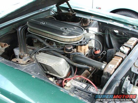 Green engine bay with V8 engine, air cleaner, and radiator